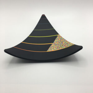 a Kiln fired glass plate in a triangle shape in black with highlights of the rainbow and molded into a bowl shape. The murrine is hand made by Renee Farr.