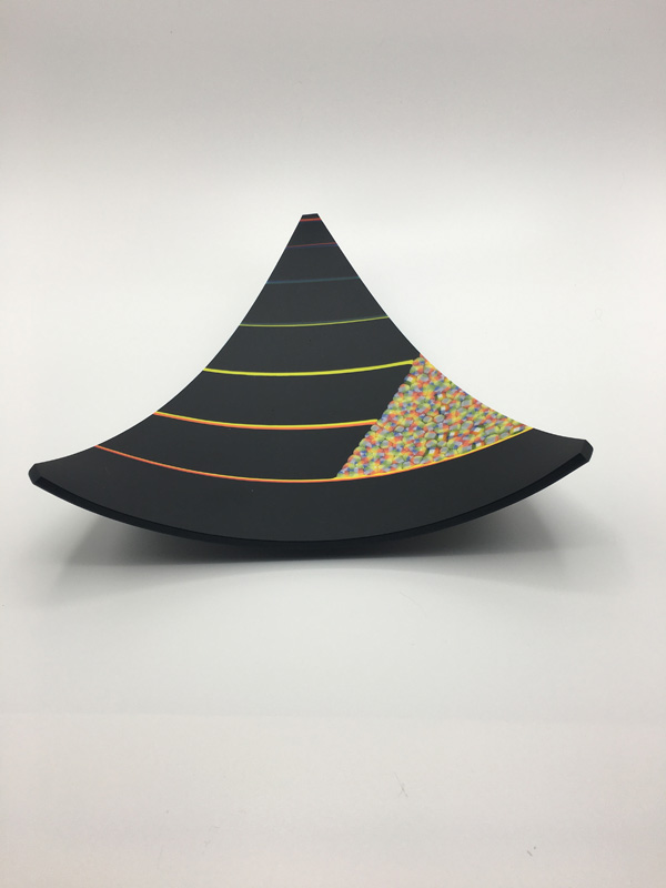 a Kiln fired glass plate in a triangle shape in black with highlights of the rainbow and molded into a bowl shape. The murrine is hand made by Renee Farr.