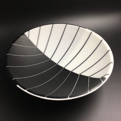 Kiln fired glass bowl in white and black. The design is intended to be an optical illusion of depth. by Renee Farr