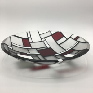 Kiln fired glass bowl in black, white, red and clear. Bowl is reflective of the Mondrian style. The bowl is matte finish with a shined rim